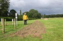 Councillor Matt Swindlehurst at Birchall playing fields where work is now underway to install an exercise path around the boundary of the site.
