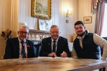 Councillor Chris Wood, Councillor Mike Gledhill and Dan Pearson sign the Protocol at Moorlands House.